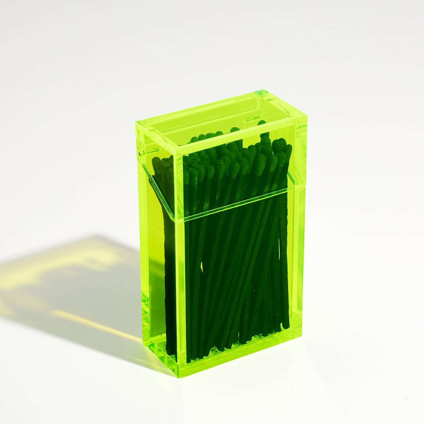 Closed Opened Match holder shaped like a Cigarette Case. Made with neon green acrylic. Case holds Black matches in it.