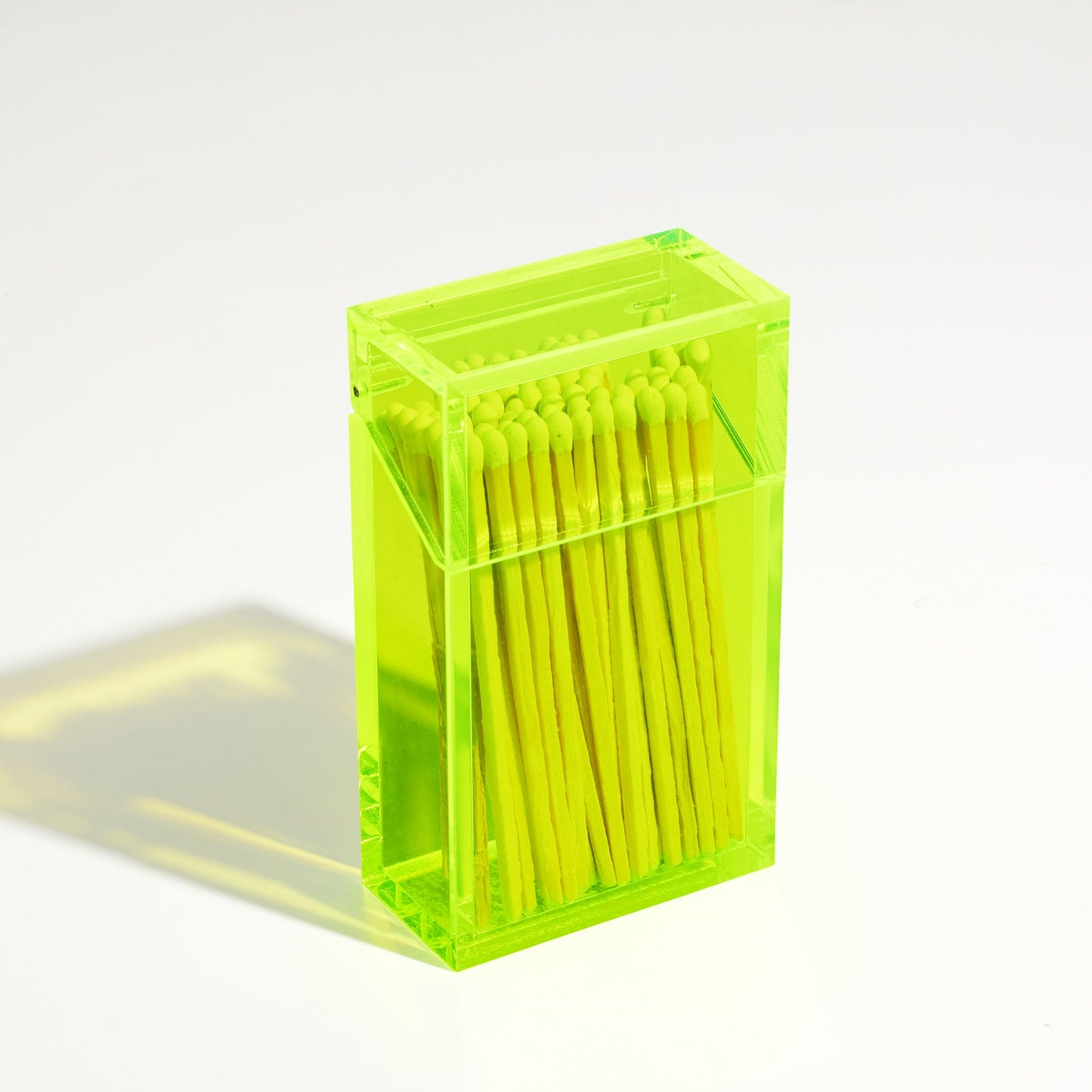 Closed Opened Match holder shaped like a Cigarette Case. Made with neon green acrylic. Case holds White matches in it.