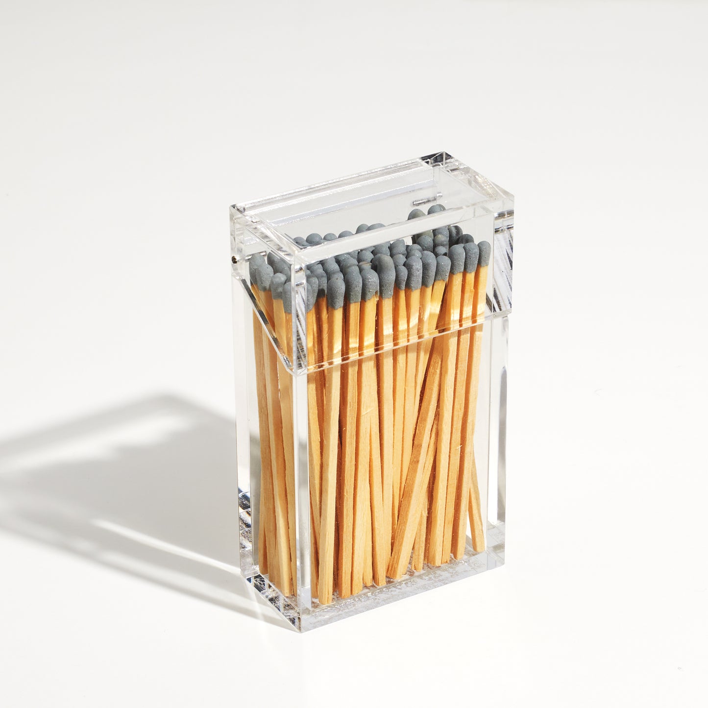 Closed Match holder shaped like a Cigarette style acrylic case with Gray matches in it.
