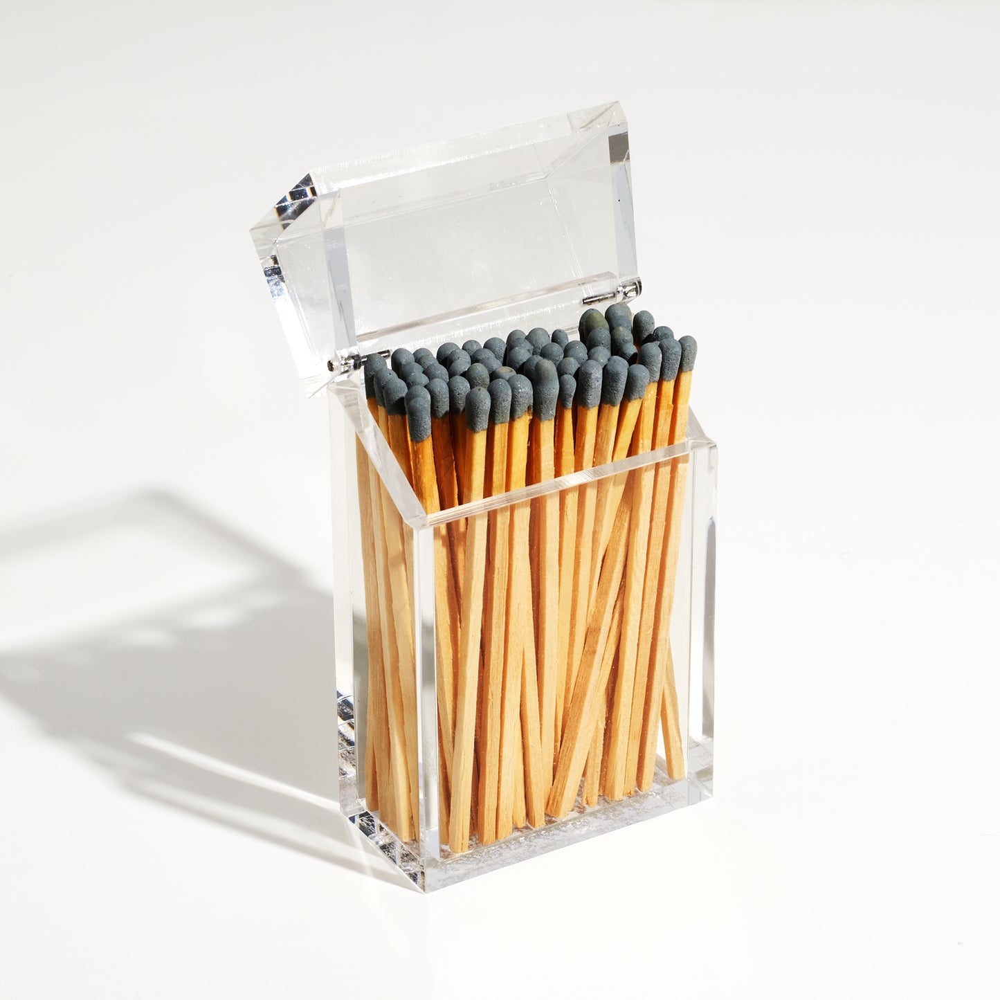 Open Match holder shaped like a Cigarette style acrylic case with gray matches in it.