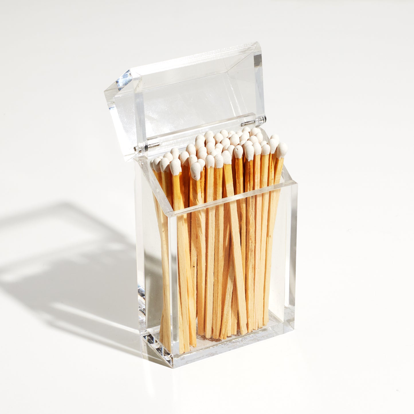 Match holder shaped like a Cigarette style acrylic case with matches in it.