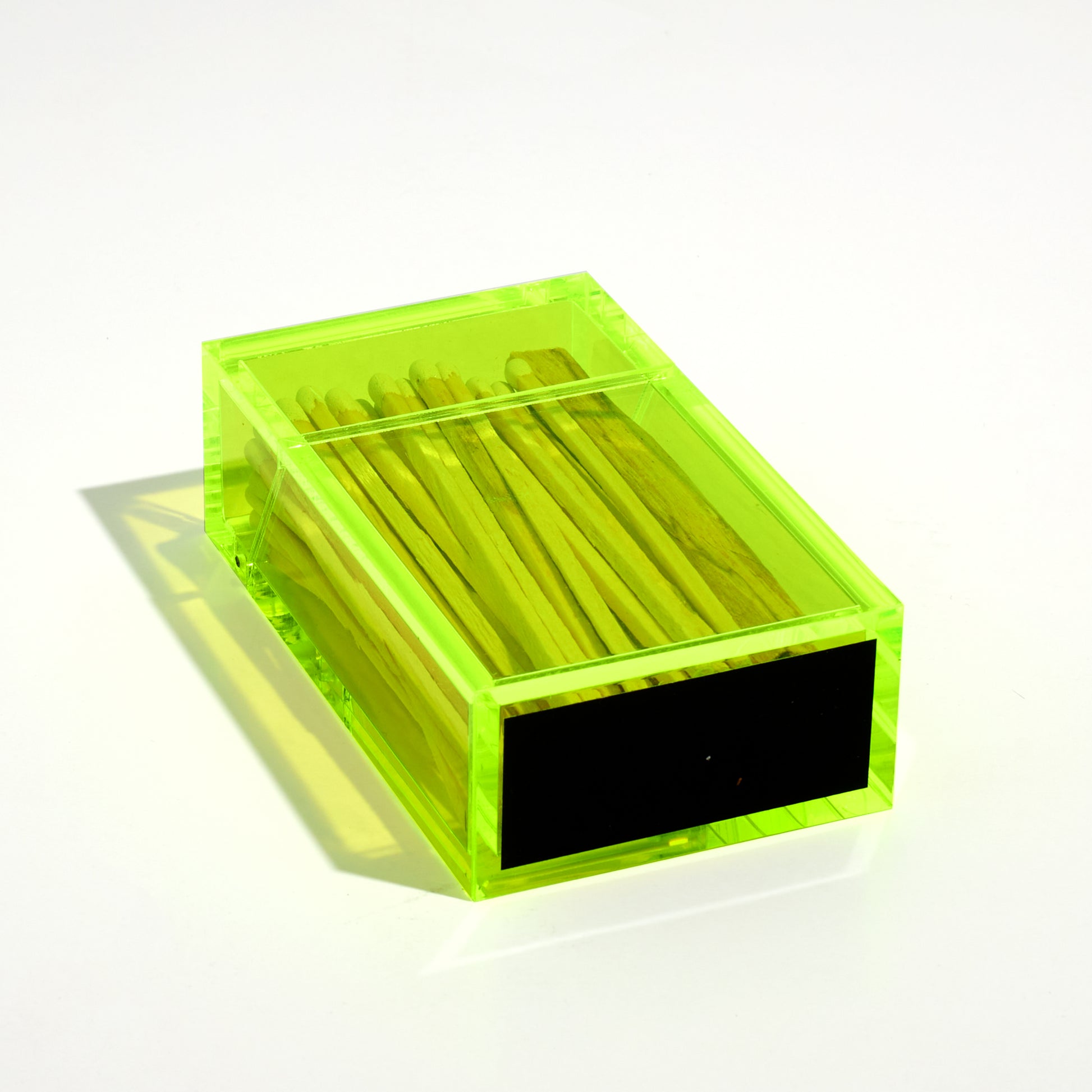 Cigarette style acrylic case with white matches and palo santo. Item is laying flat to feature the match striker at the bottom. 
