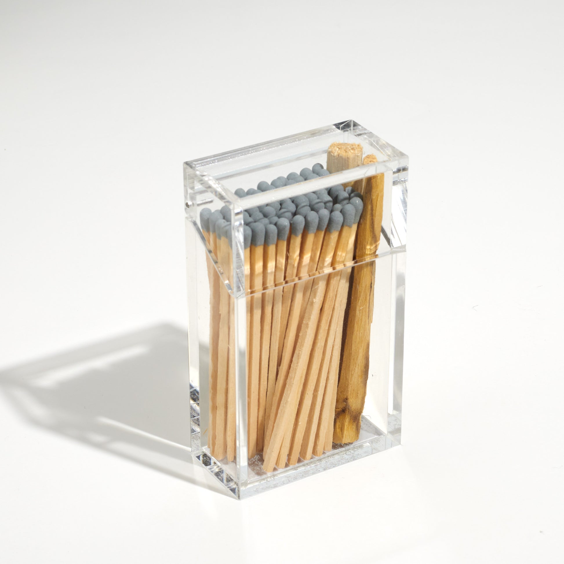 Closed Cigarette style acrylic case with Gray matches and palo santo in it. 