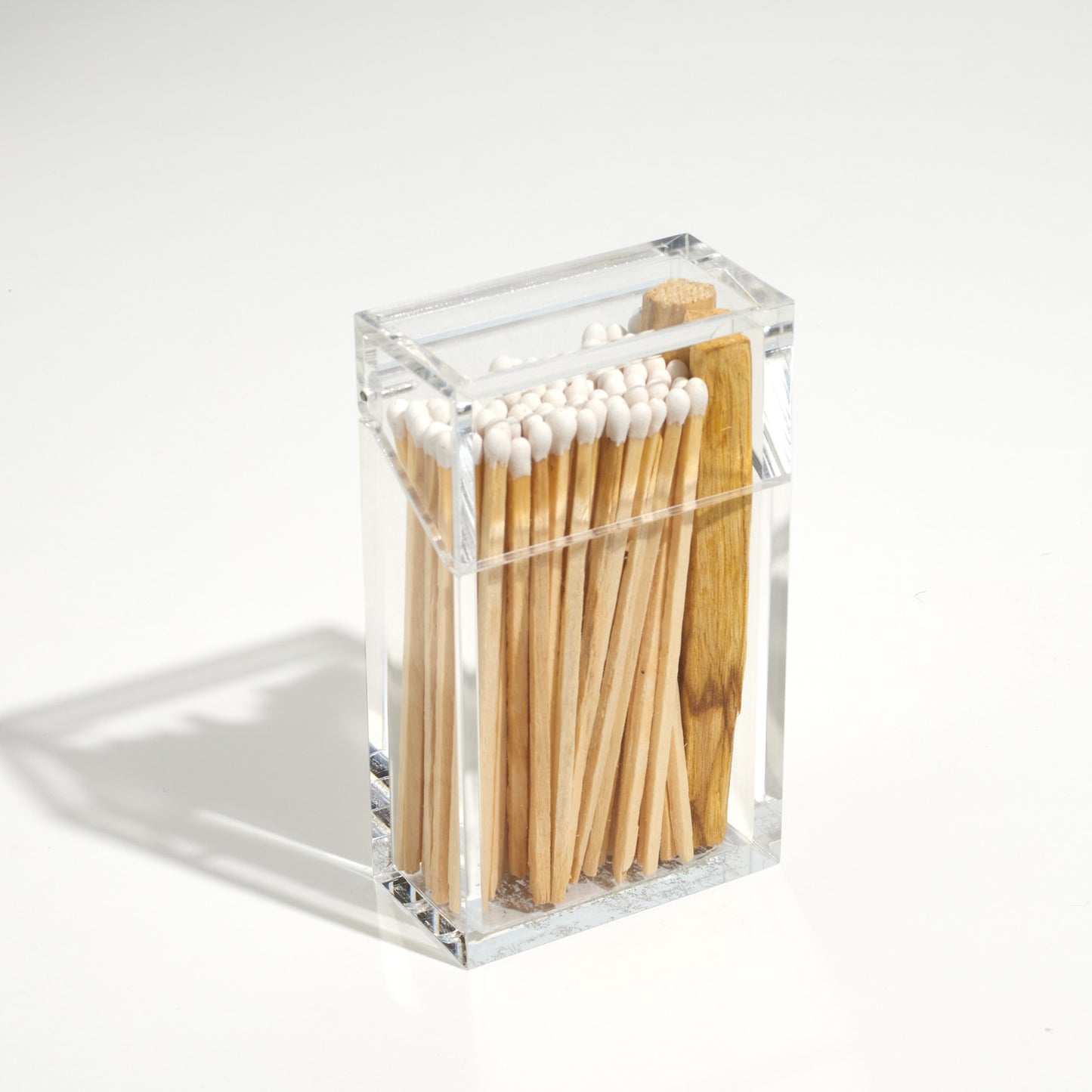 Closed Cigarette style acrylic case with white matches and palo santo in it. 