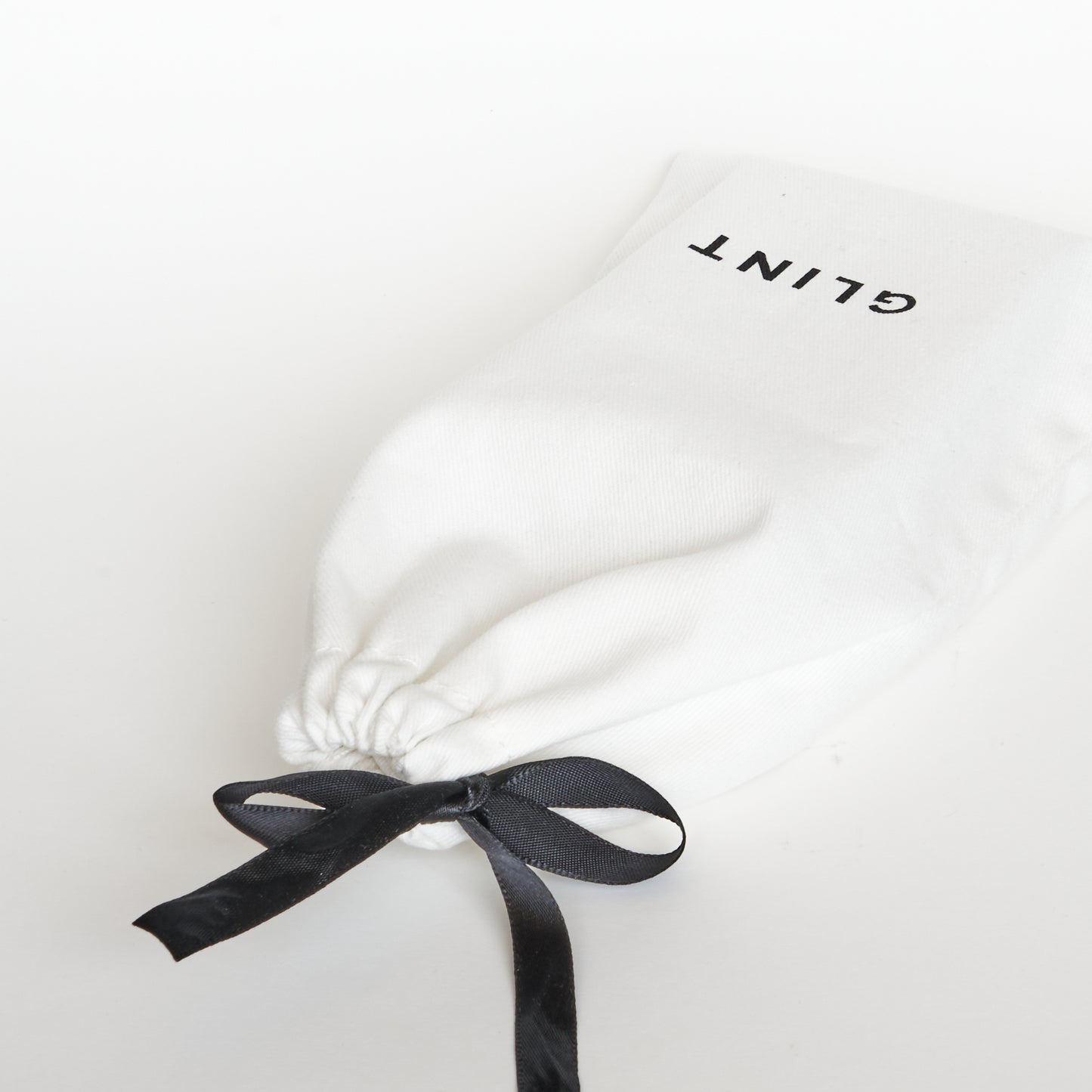 Drawstring bag with Glint Logo on it. This comes free with purchase.